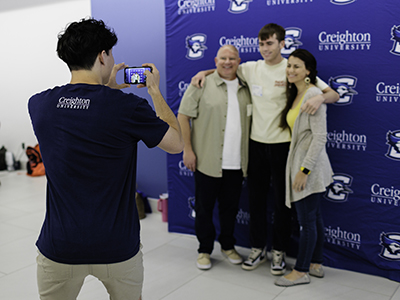 Students taking photo with family